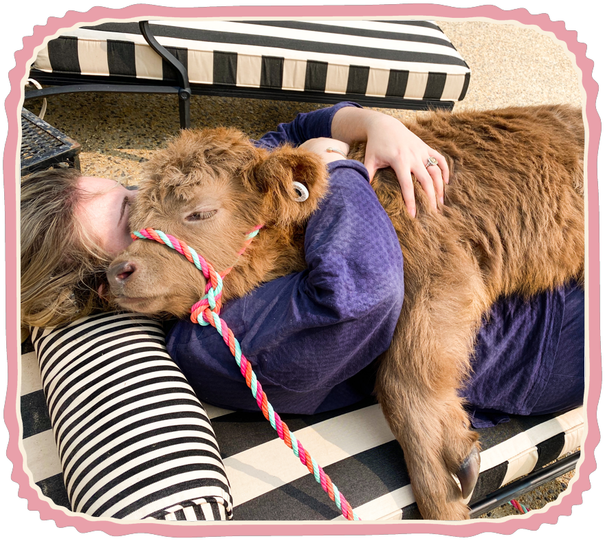 The author snuggling baby Charlsie on a striped lounge chair